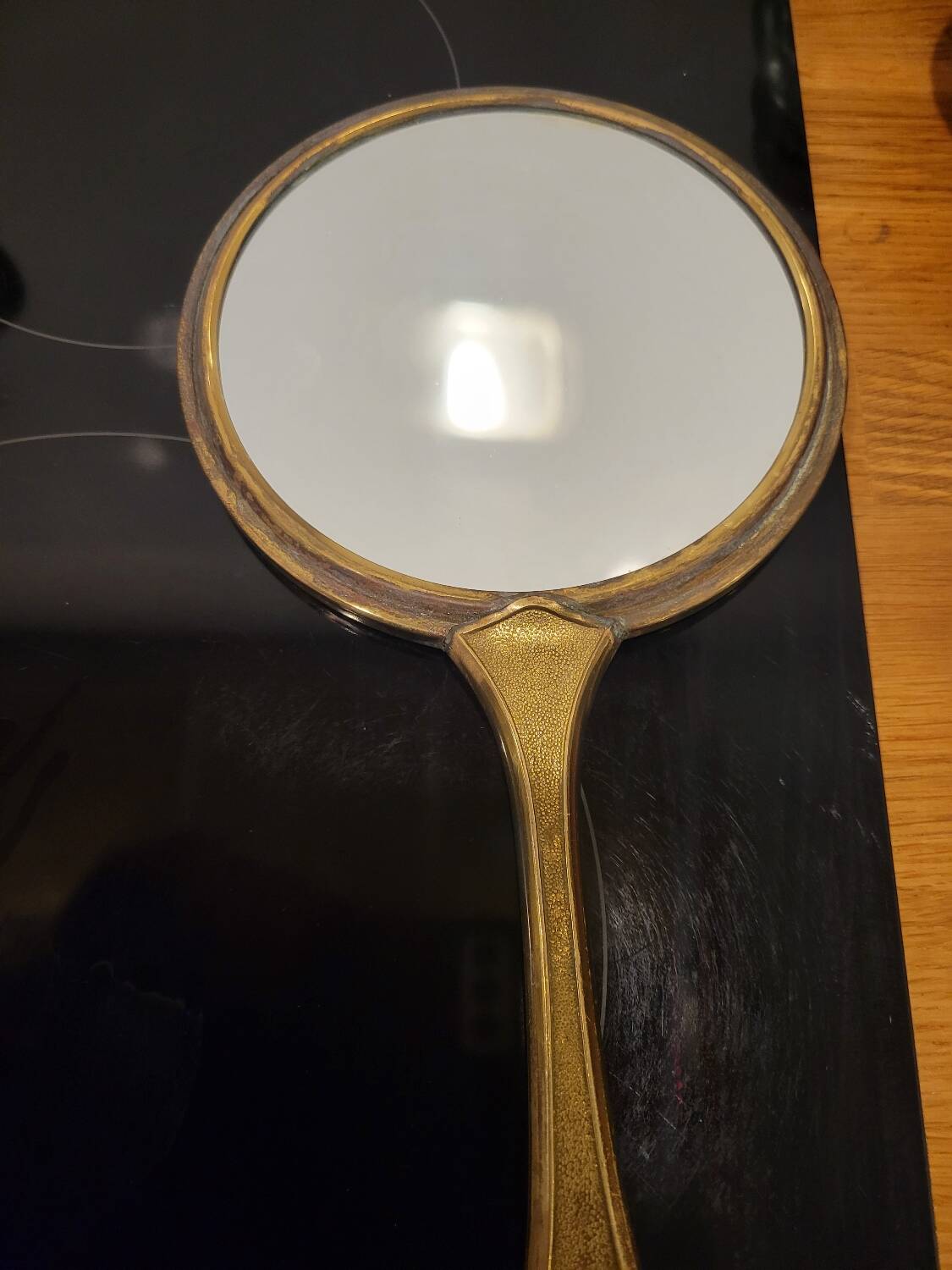 Brass hand mirror with magnifying back