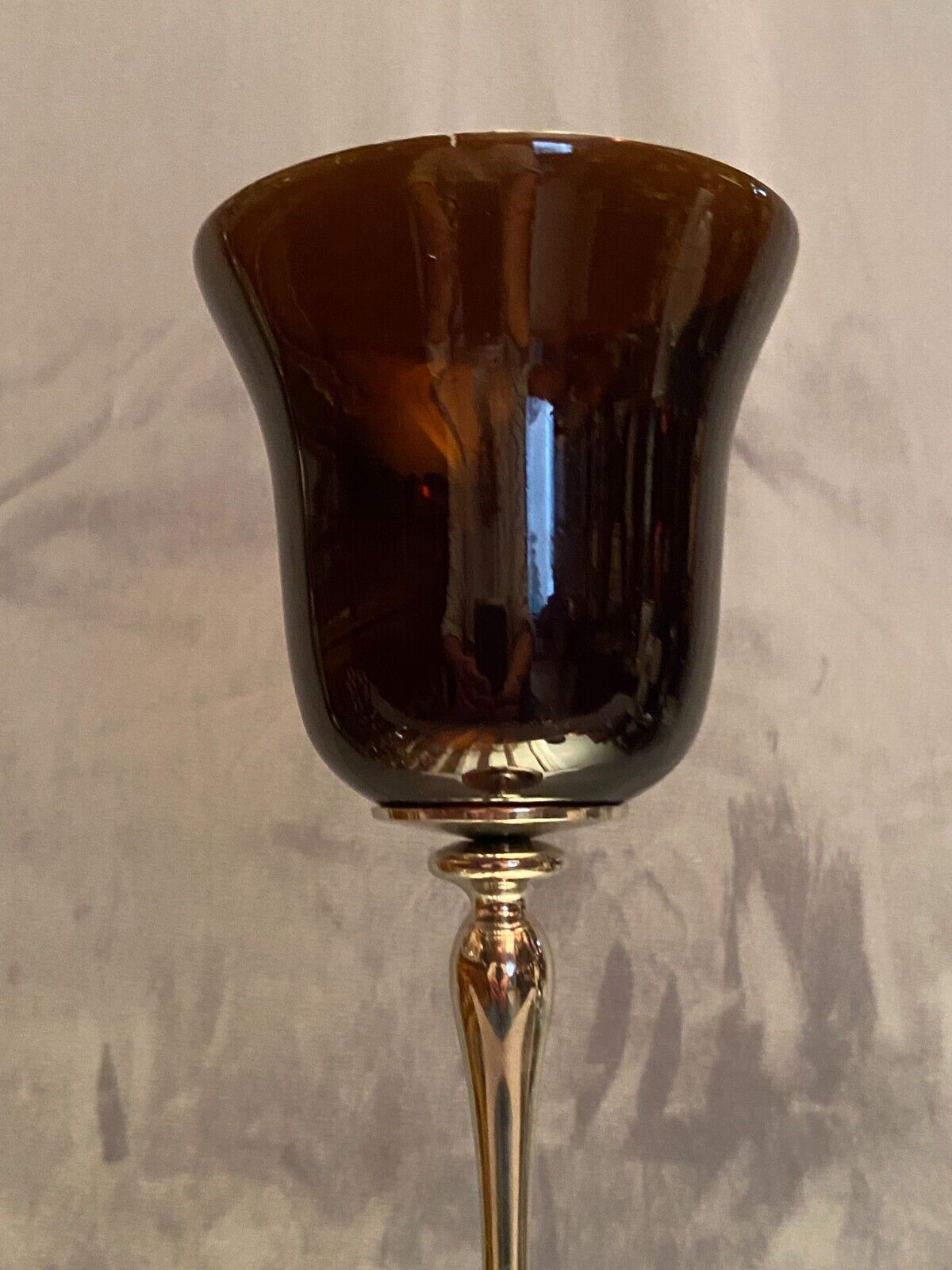 Tinted glass photophore on high metal foot with silver patina