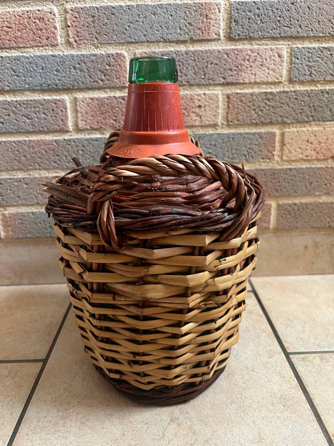 Old glass demijohn with wicker basket.
