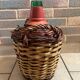 Old glass demijohn with wicker basket.