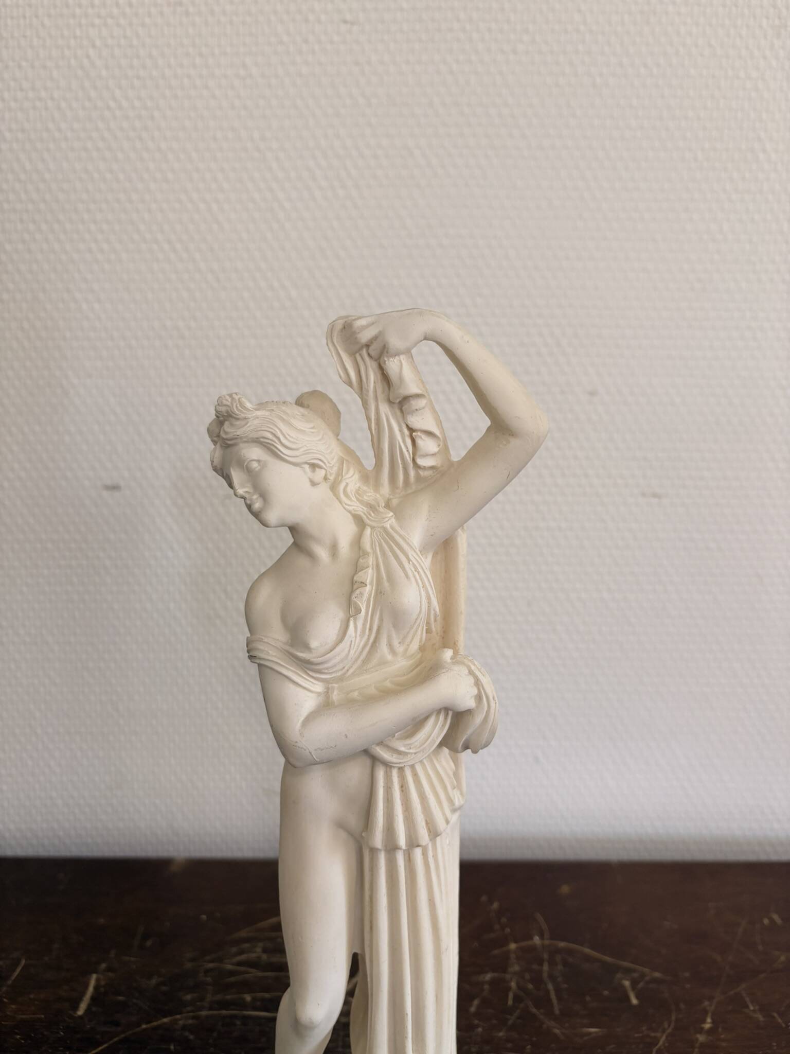 Sculpture of a bathing nymph in neoclassical style, made of plaster.