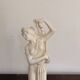 Sculpture of a bathing nymph in neoclassical style, made of plaster.