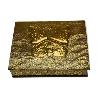 Old wooden box decorated with carved gold metal repelled vintage butterfly
