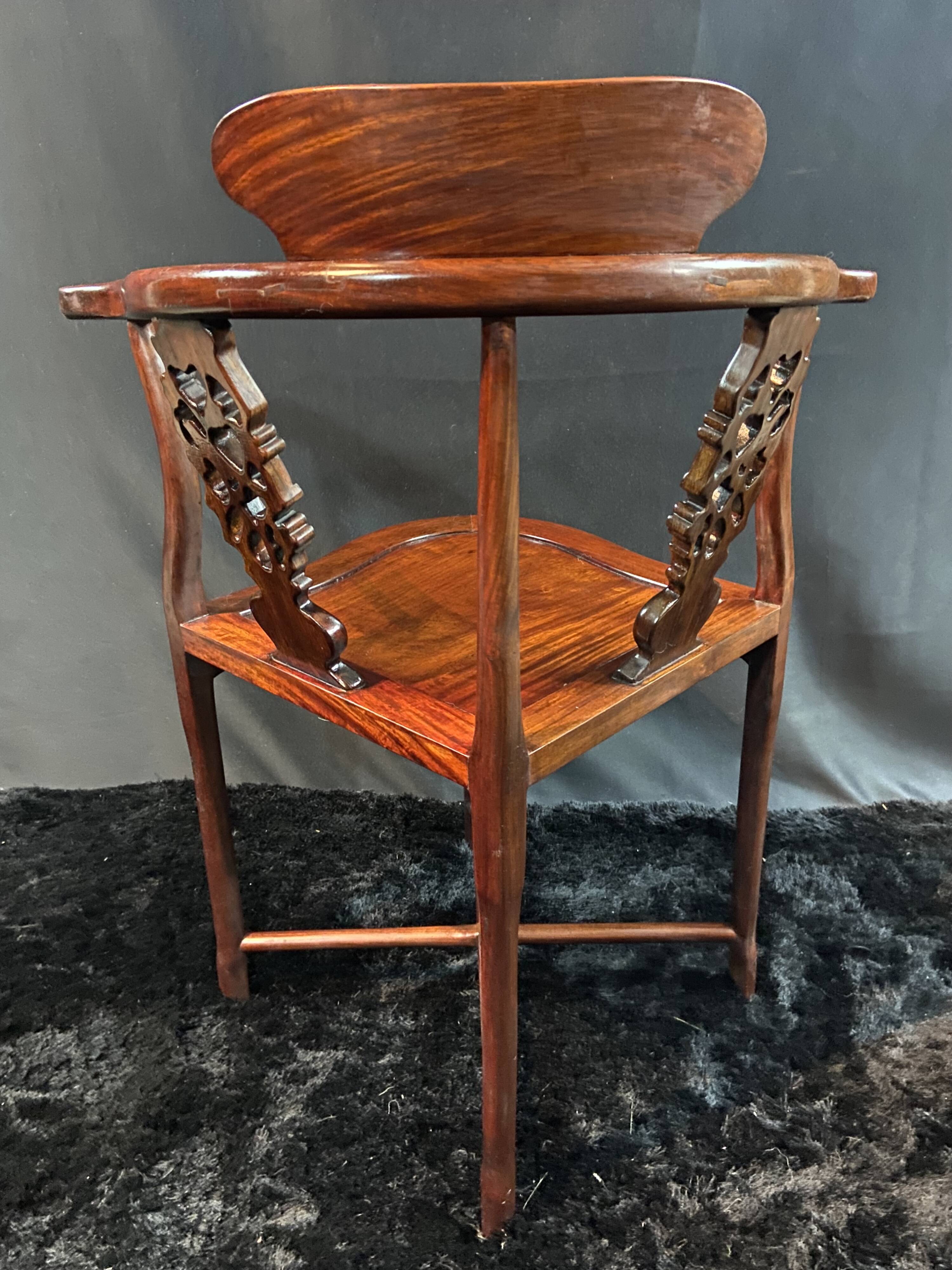 Corner armchair in solid wood with carved floral decoration featuring a bird.