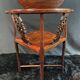 Corner armchair in solid wood with carved floral decoration featuring a bird.