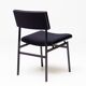Set of four entirely black Hulmefa dining chairs, Architectural Modernism.