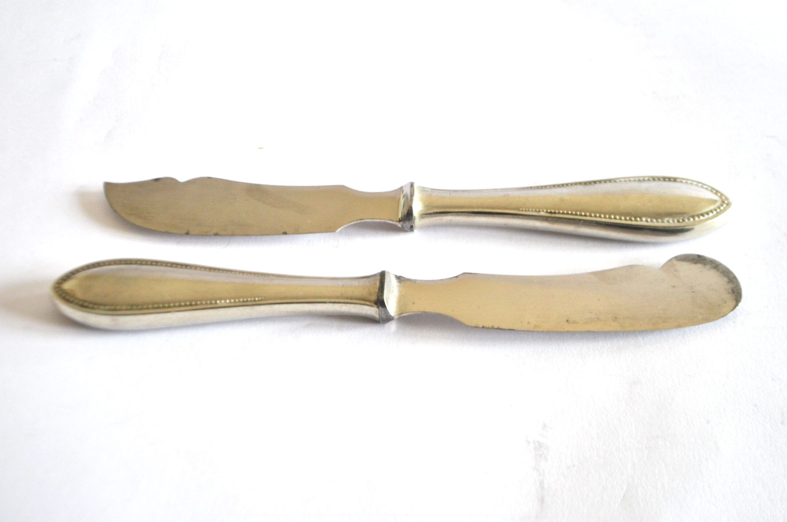 Two antique service knives in silver-plated metal, pearl frieze gowe alpacca.