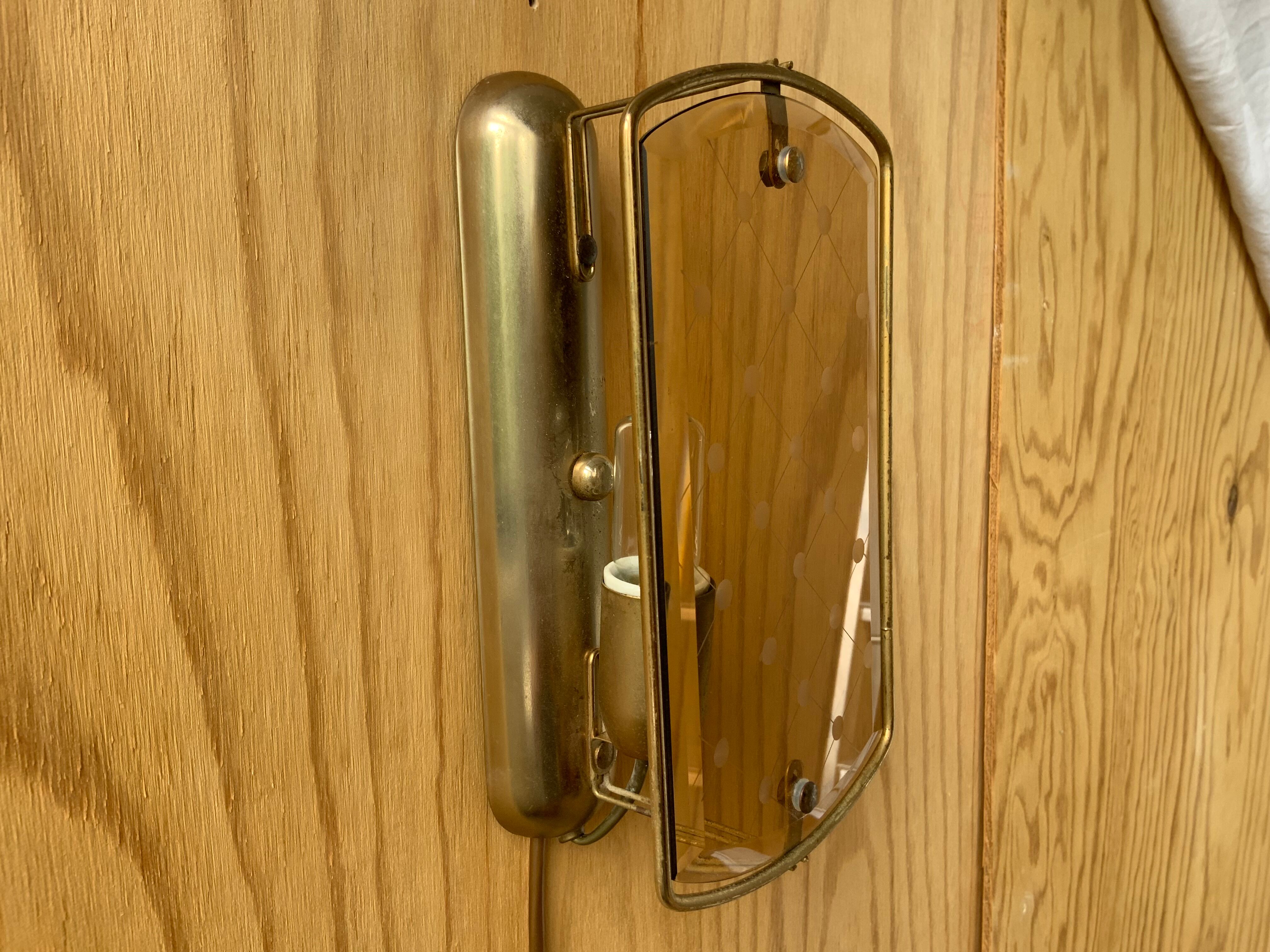 Brass wall lamp and smoked glass