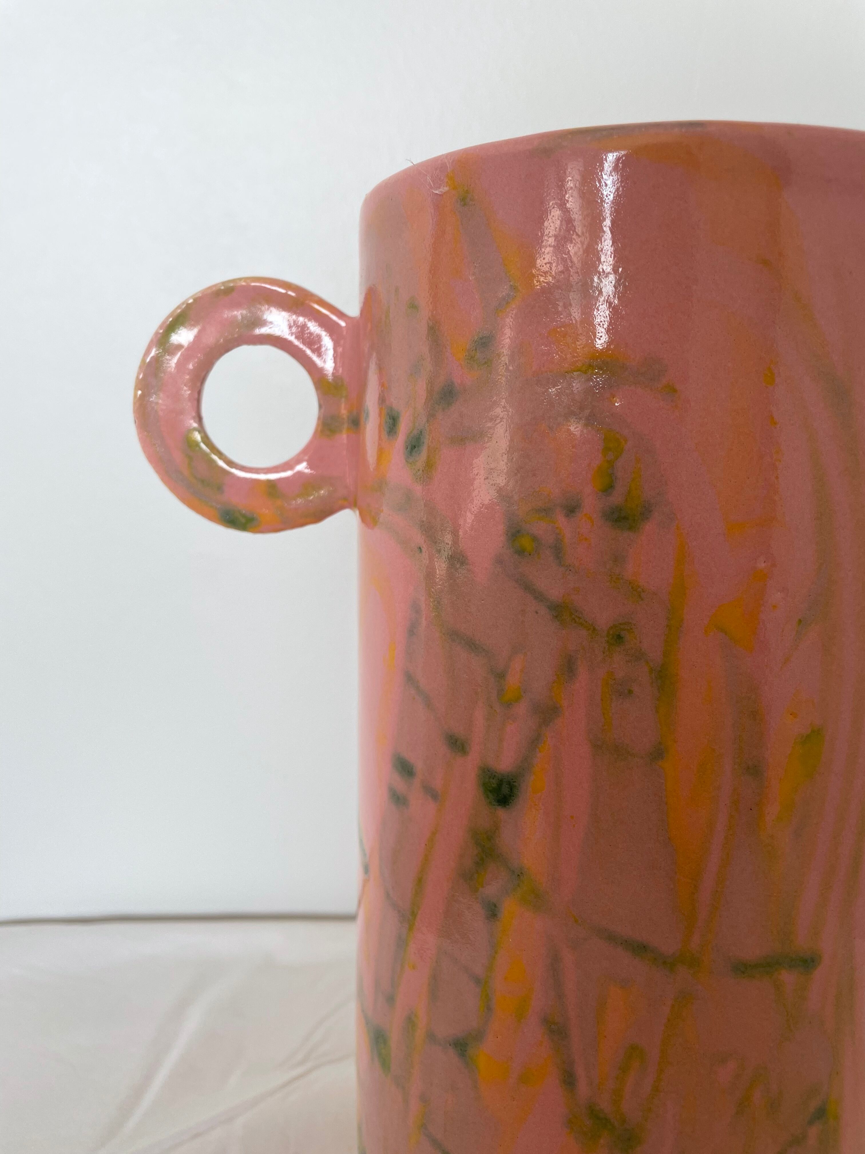Pink ceramic vase with abstract circular handles