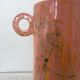 Pink ceramic vase with abstract circular handles