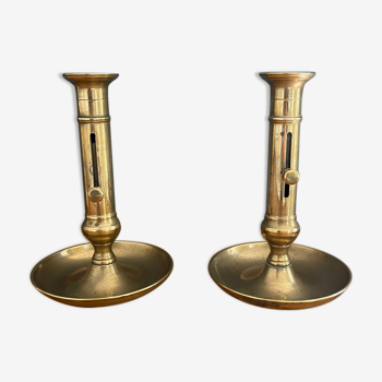 Pair of golden brass candle holders with pusher