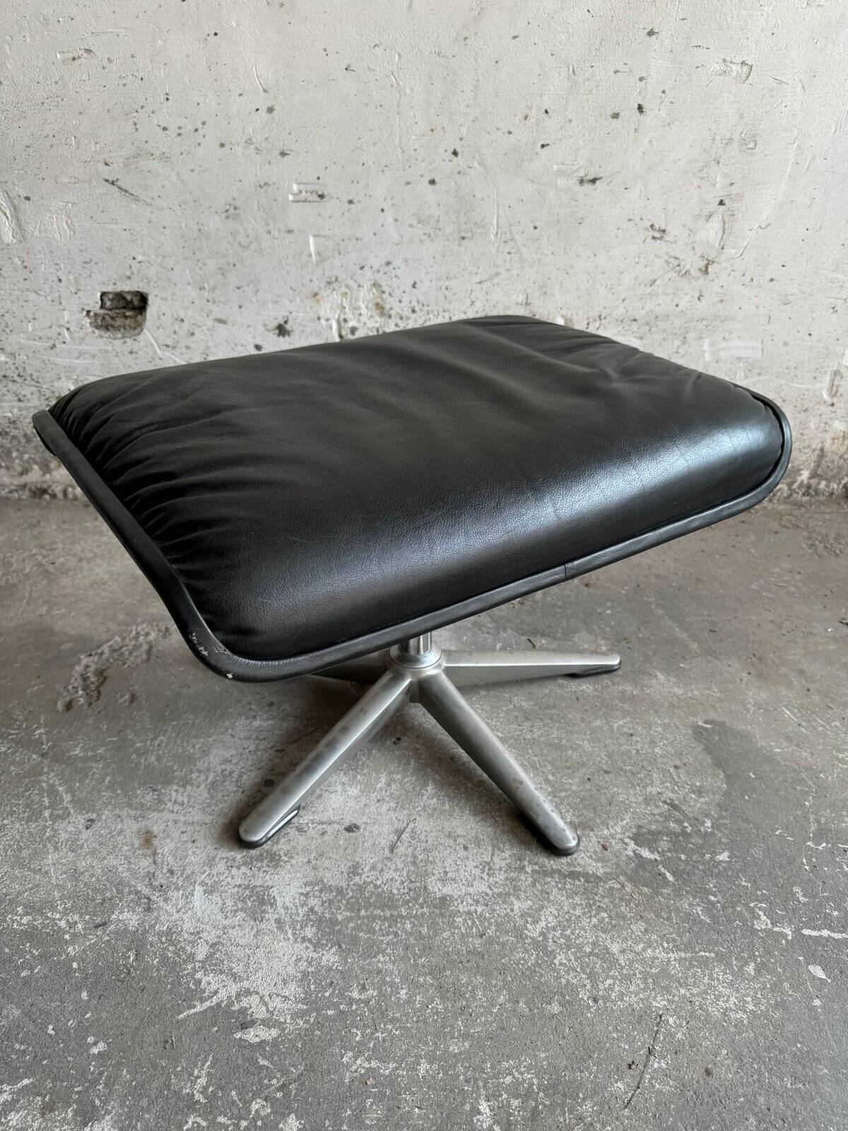 Wilkhahn Delta lounge chair in black leather with polished aluminum base and footrest (1970s)