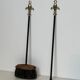 Neoclassical-style fire accessory in black lacquered metal and brass with fleur-de-lis.