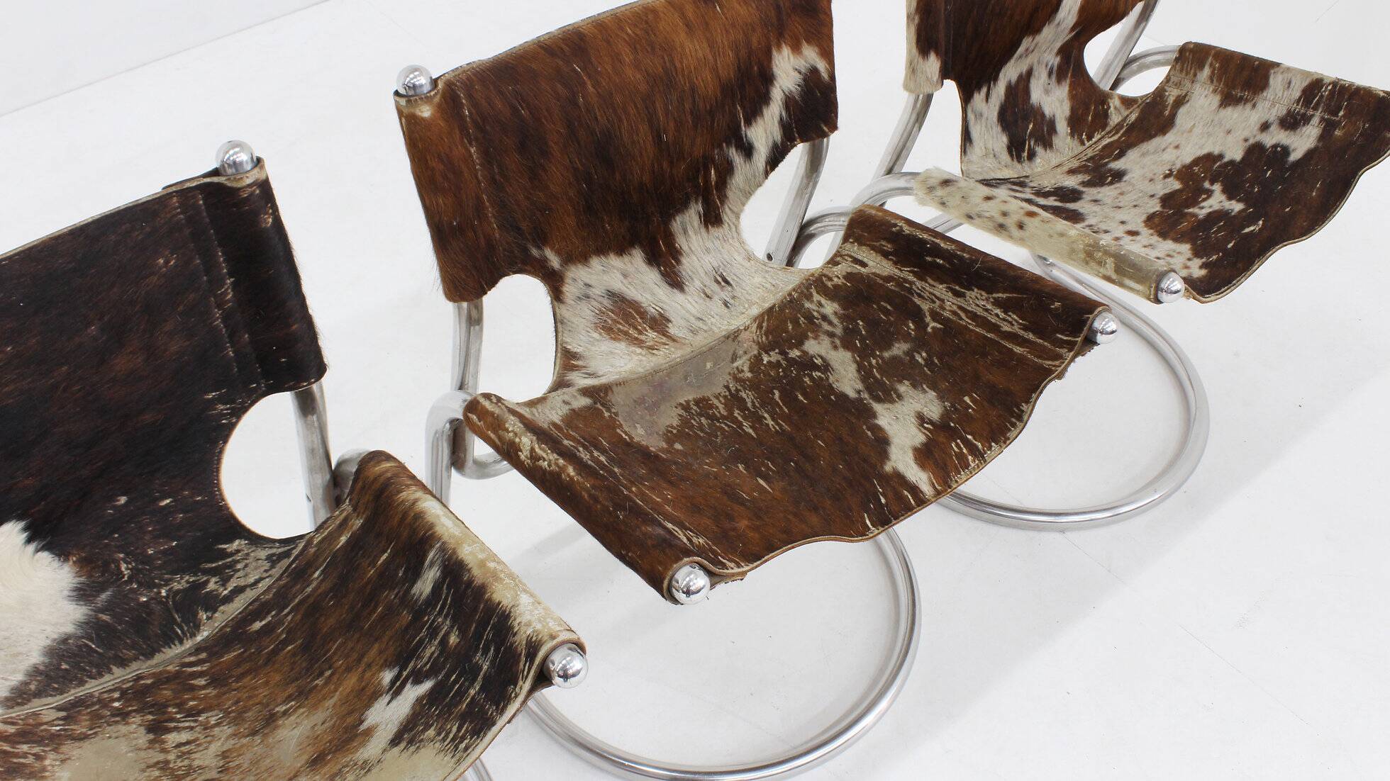 Vintage dining room chairs chrome and cowhide by Parravicini Fratelli