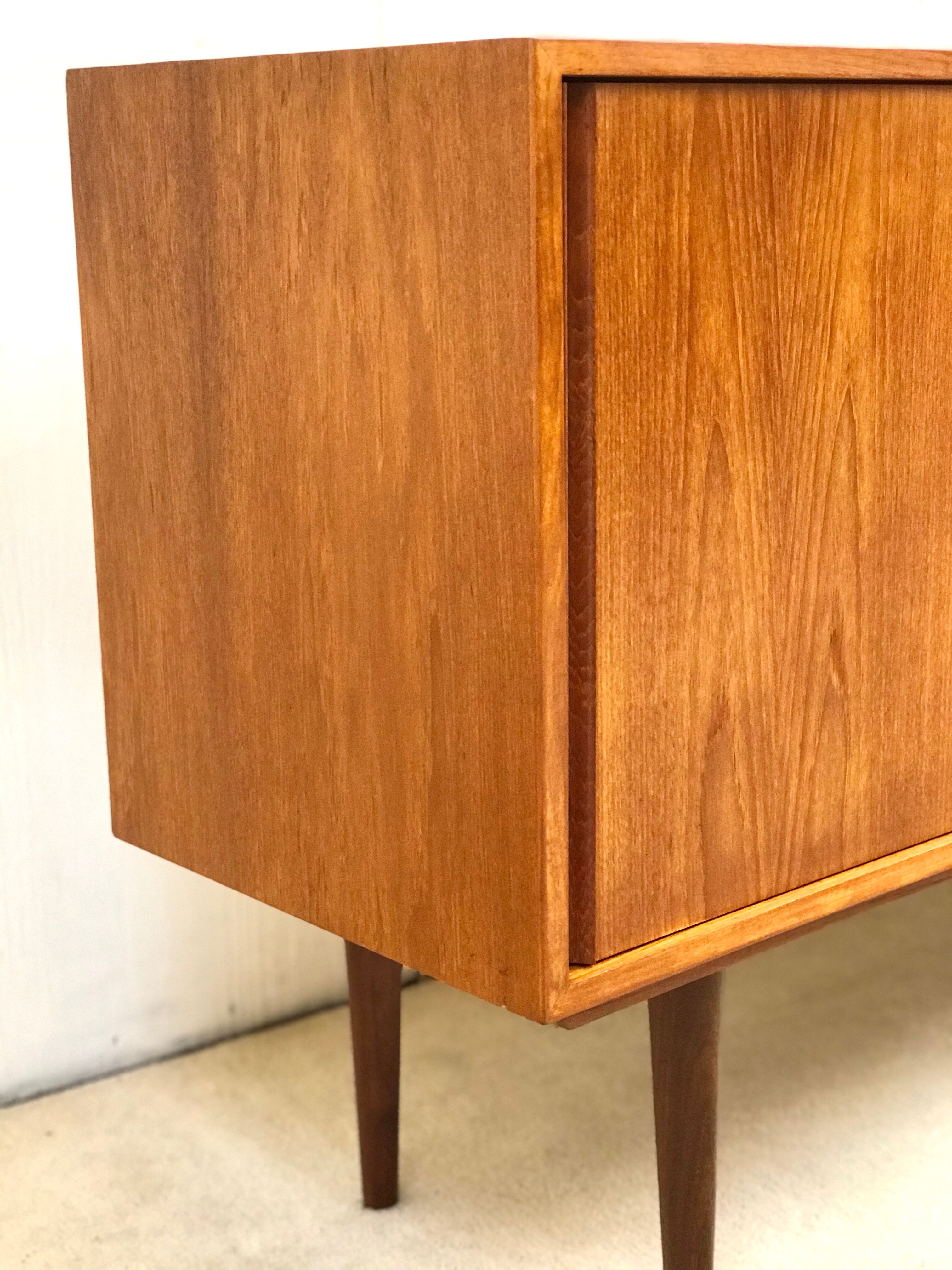 Danish teak sideboard with two sliding doors and 4 central drawers