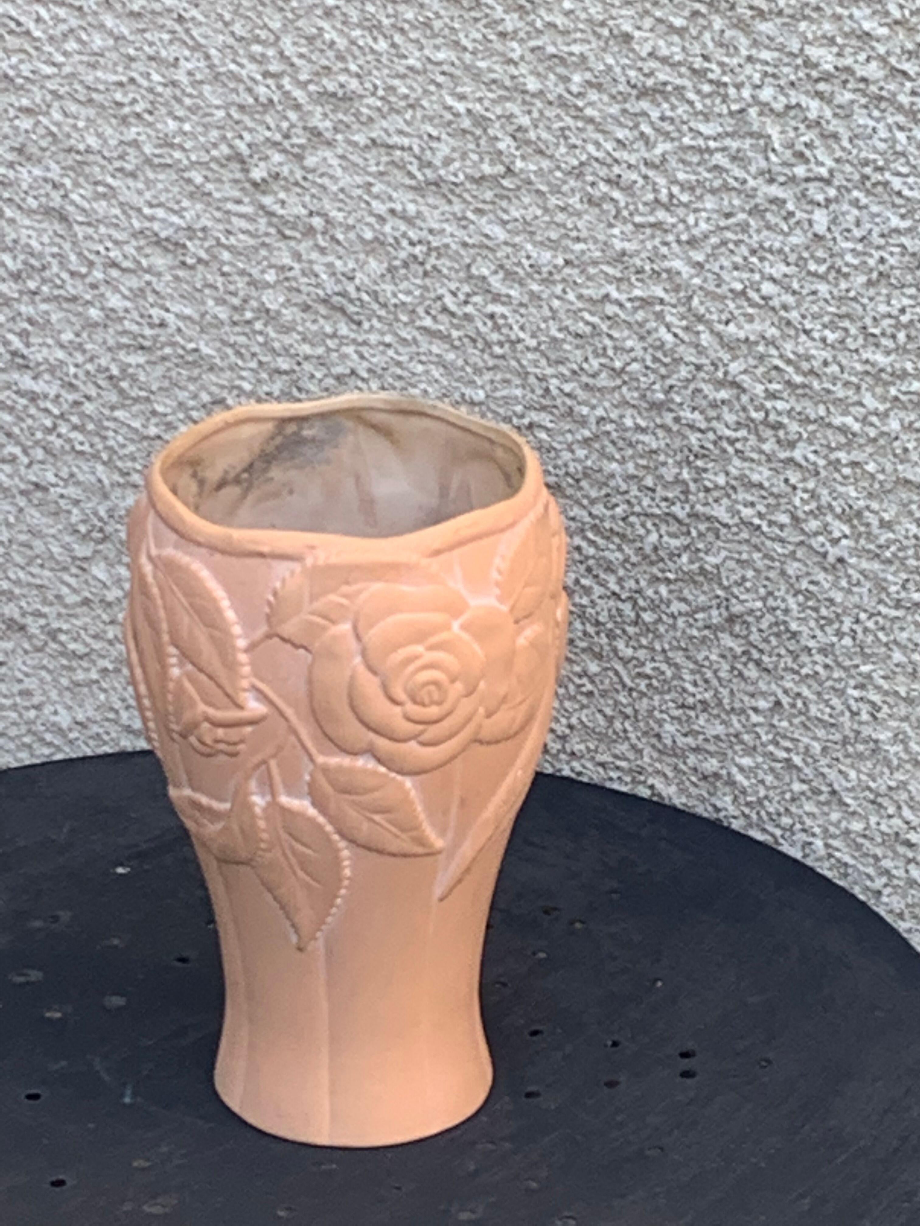 Terracotta vase with a vintage ceramic relief rose pattern