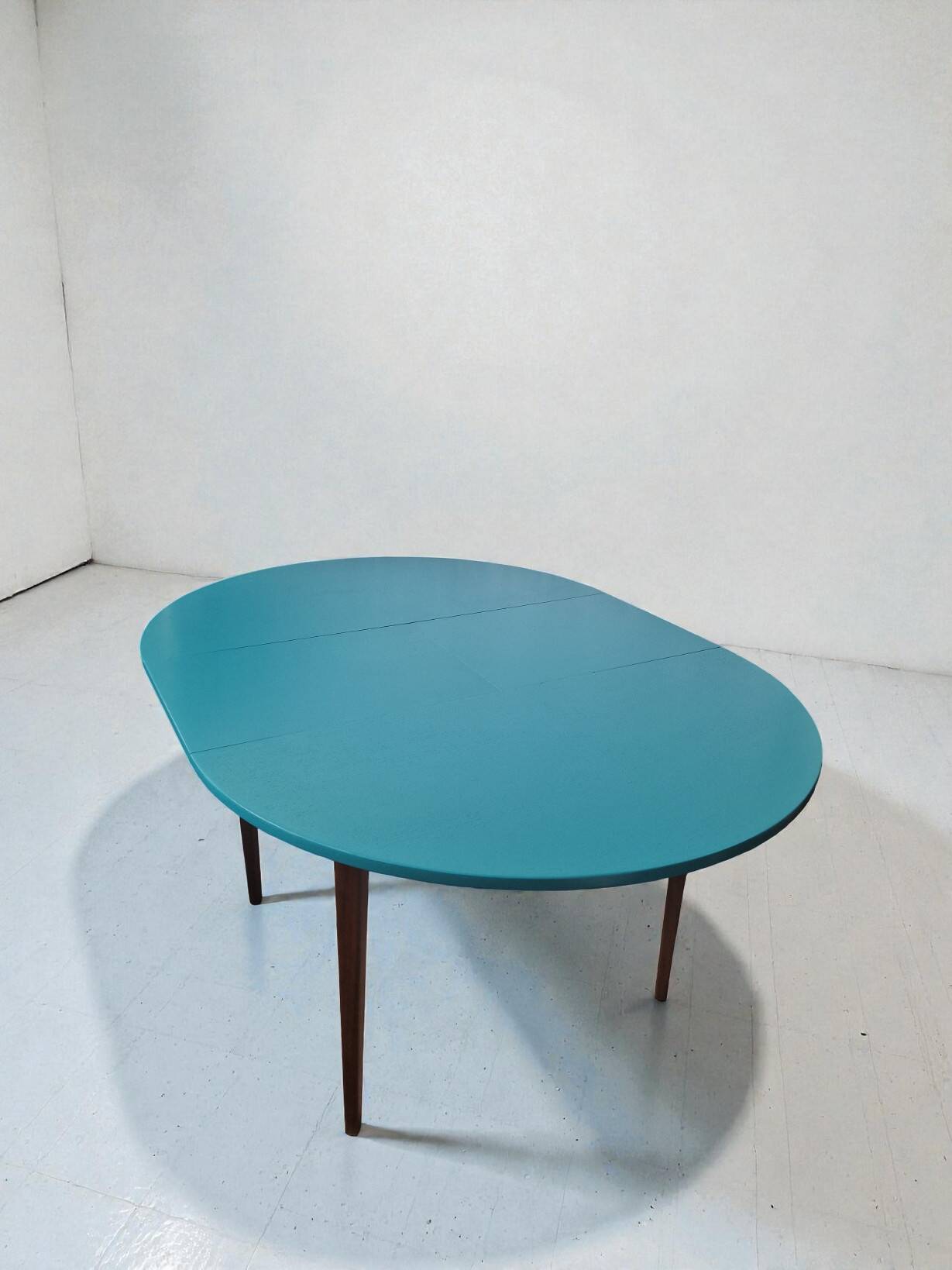 Extendable oval teak dining table