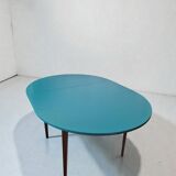 Extendable oval teak dining table