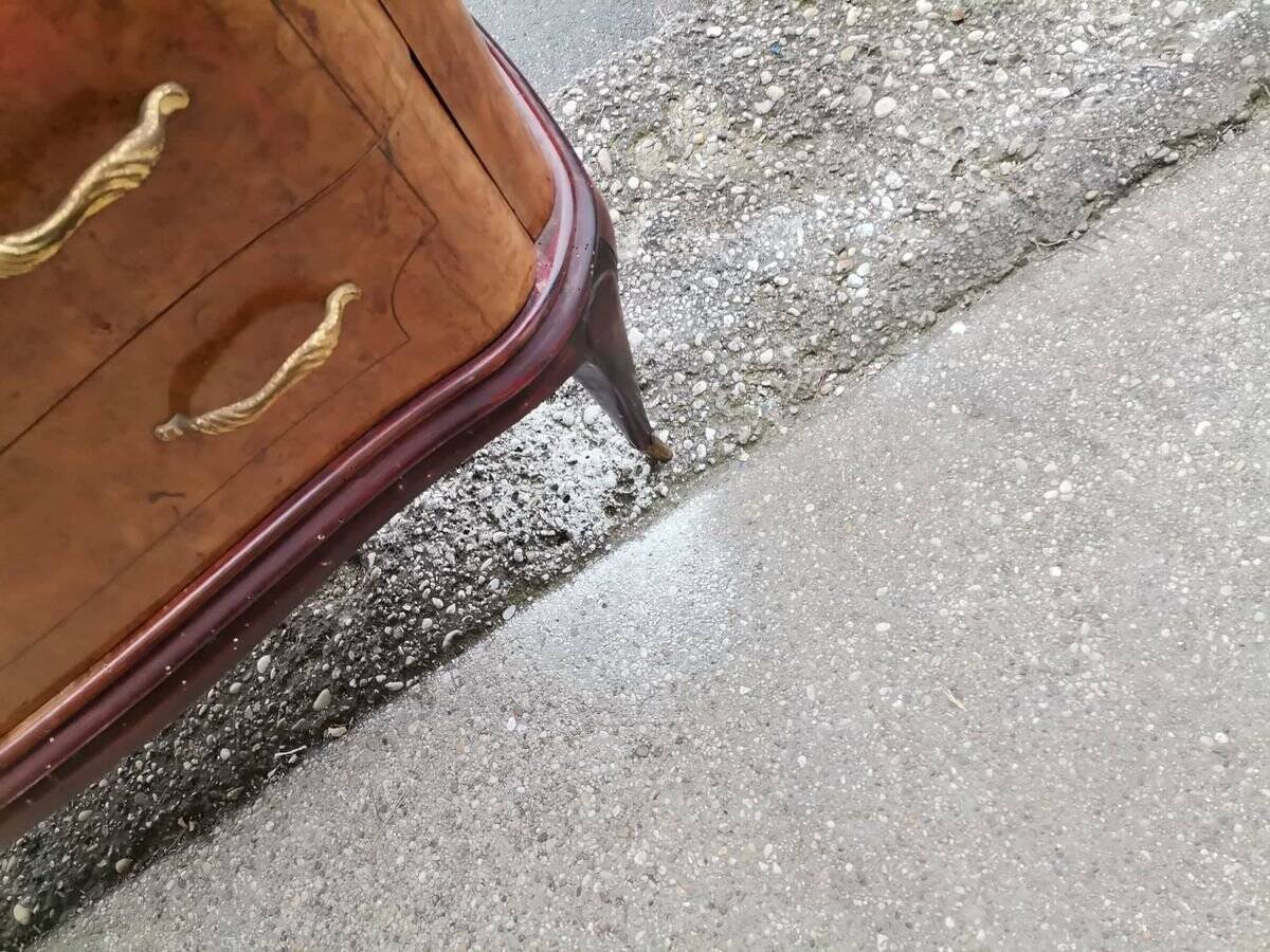 Mid-century Italian brown wooden chest of drawers, black glass top and brass handles.