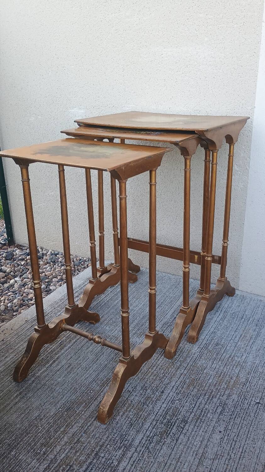 Sets of three nesting tables with painted landscape decorations in poplar.
