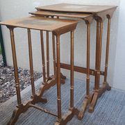 Sets of three nesting tables with painted landscape decorations in poplar.
