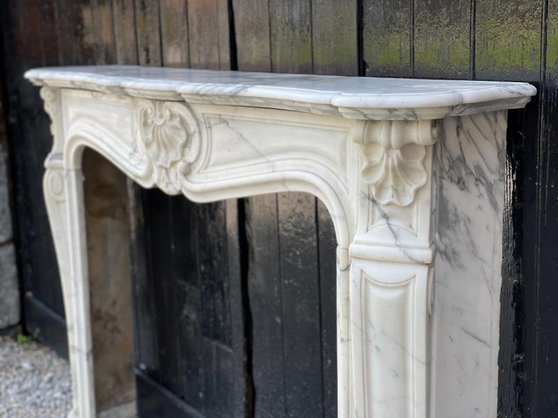 Louis XV style fireplace in white Carrara marble arabescato