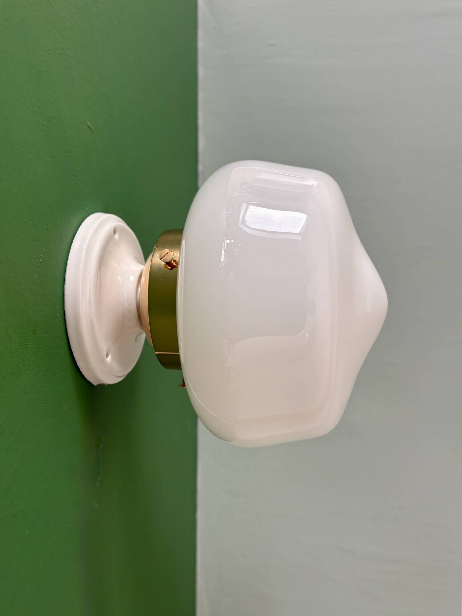 Vintage Art Deco globe wall light in white opaline.