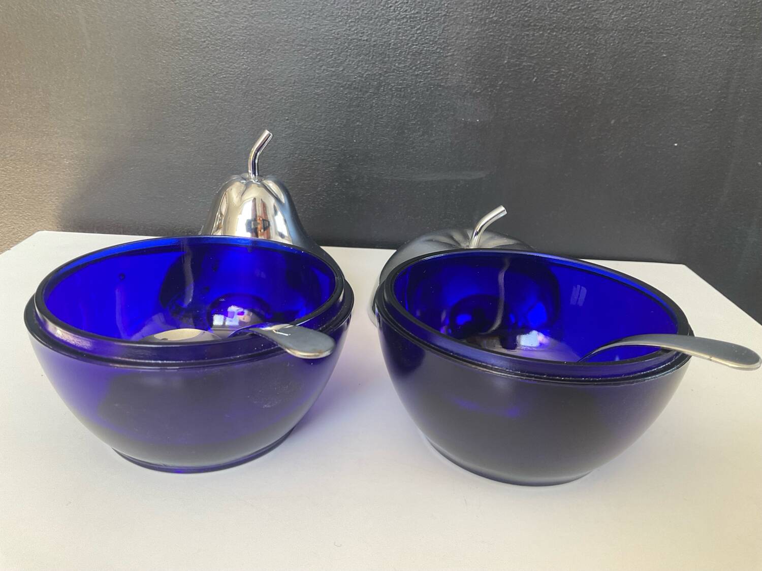A pair of vintage cobalt glass and silver-plated sugar bowls.