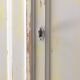 Small antique wardrobe patinated in beige and yellow.