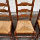4 or 5 solid wood chairs with light oak straw and high backs