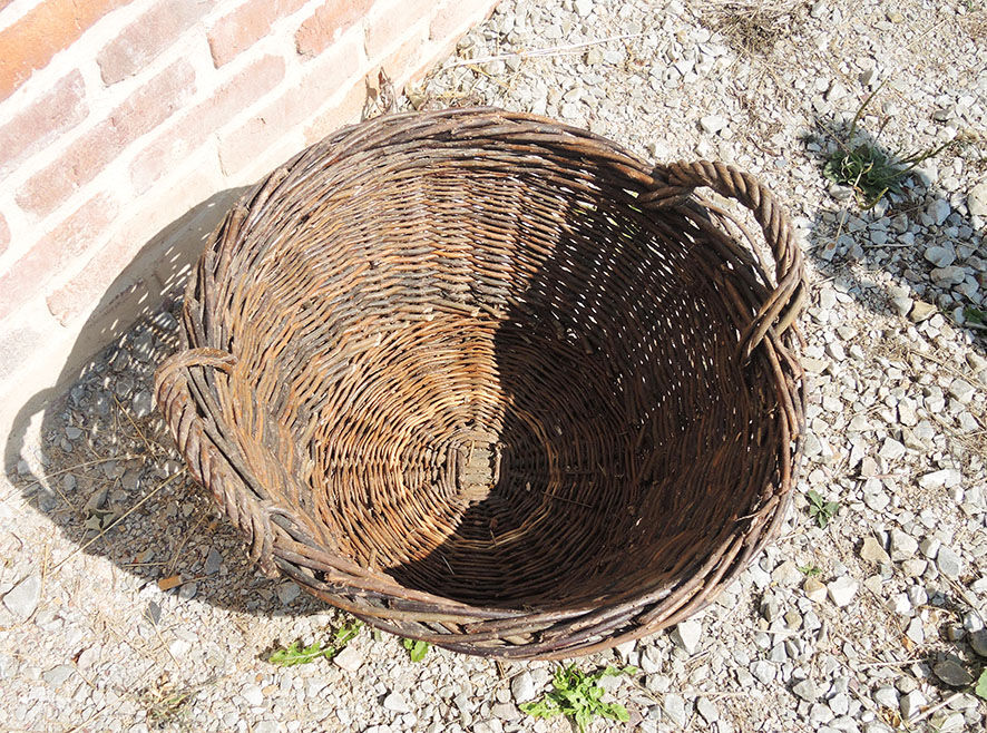 Old round wicker linen basket, dark rattan