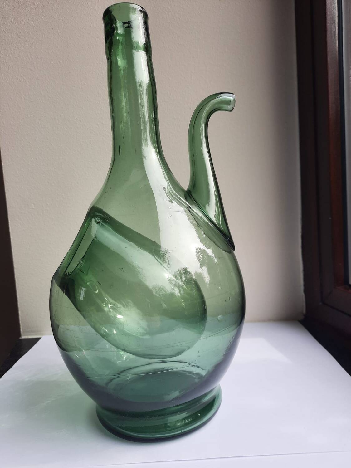 Pair of blown glass wine decanters in blue/green hues.