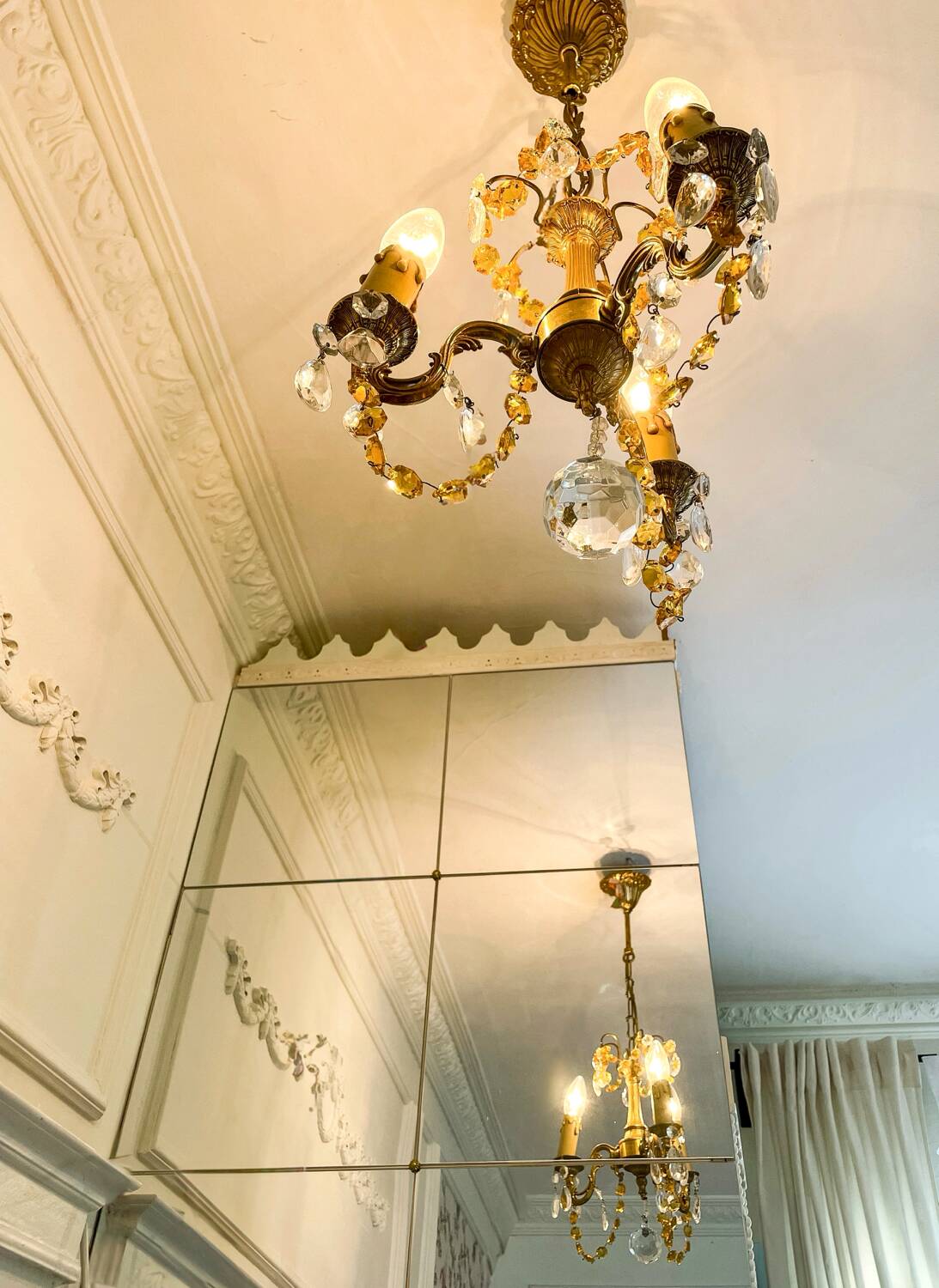 Small vintage brass chandelier with amber crystal pendants.