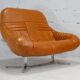 Sofa "space age". Leather, fiberglass, foam, steel. Circa 1970. Orange.