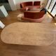 Oblong dining table in beige travertine.