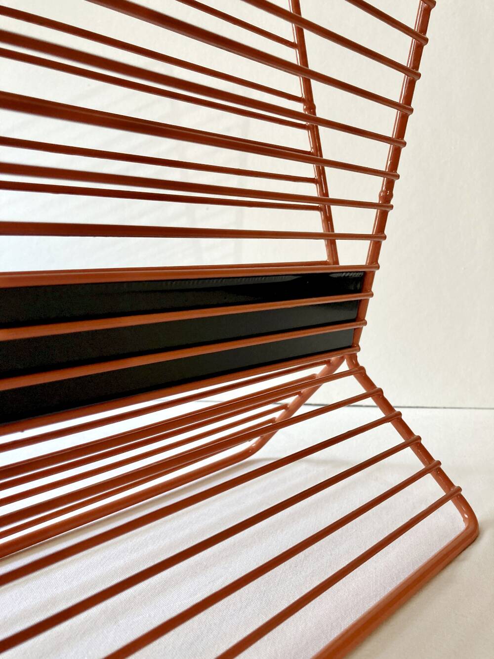 Wire metal magazine rack with triangular compartment, 1950s.