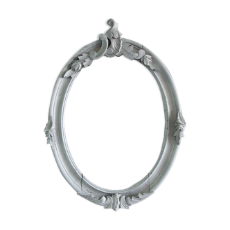 Wooden oval frame with carved pediment