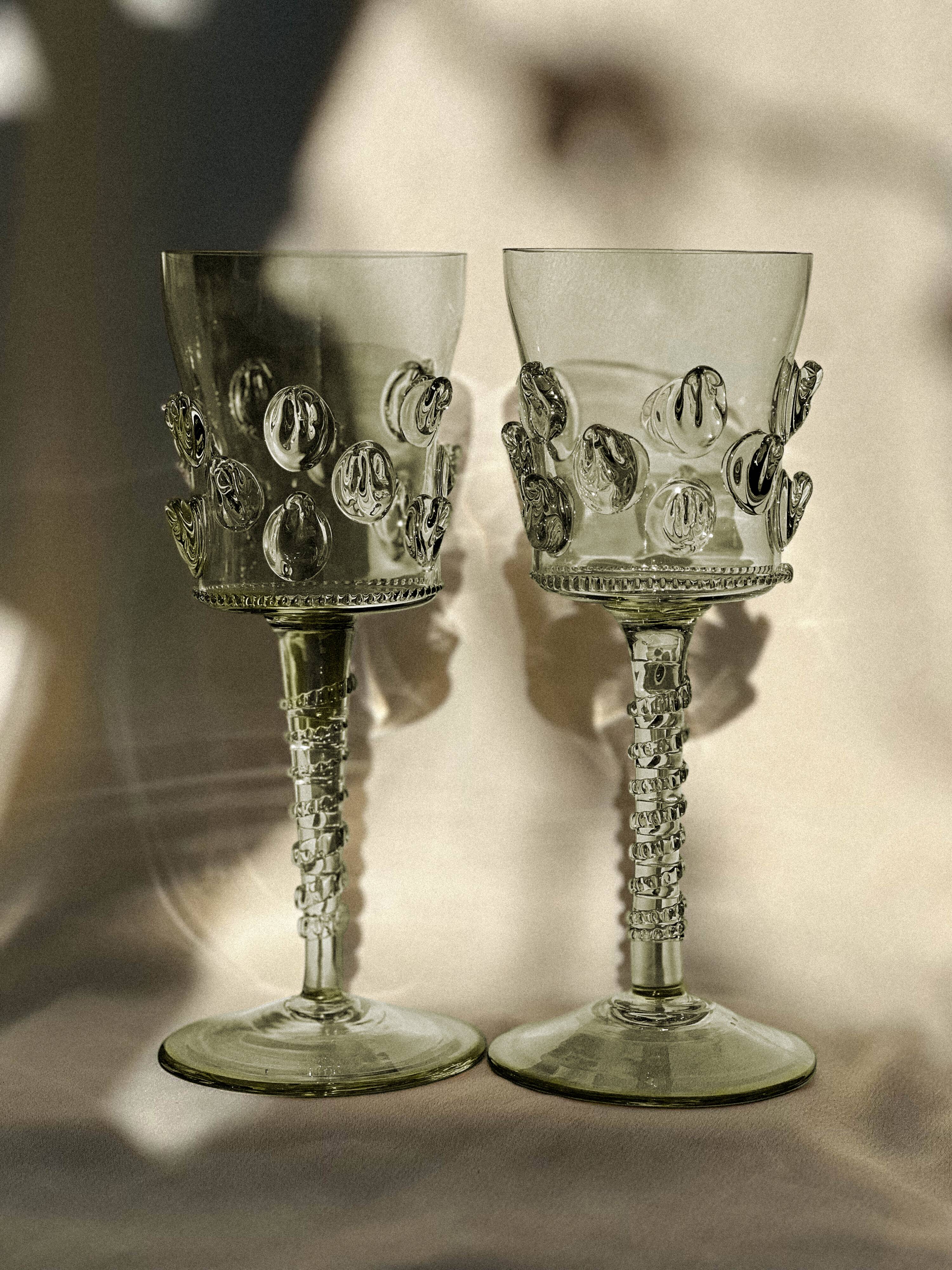 pair of blown wine glasses - green