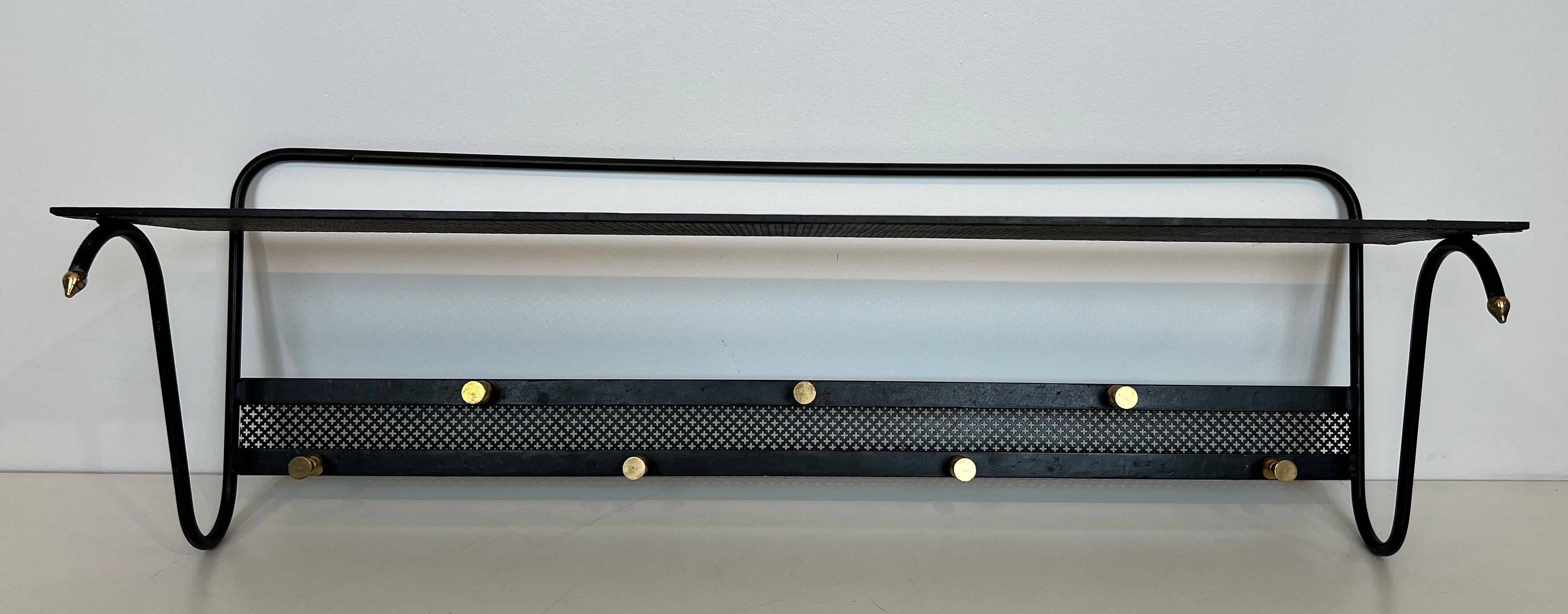 Coat rack in black lacquered metal, perforated sheet metal and brass in the style of Mathieu Matégot