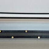 Coat rack in black lacquered metal, perforated sheet metal and brass in the style of Mathieu Matégot