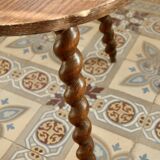 Vintage circular side table in wood with turned legs.