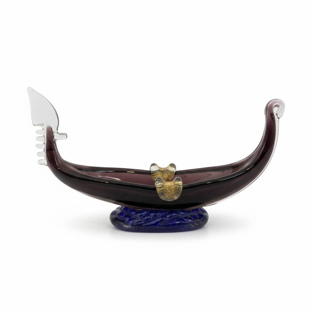 Murano glass gondola placed on a blue water-effect glass base