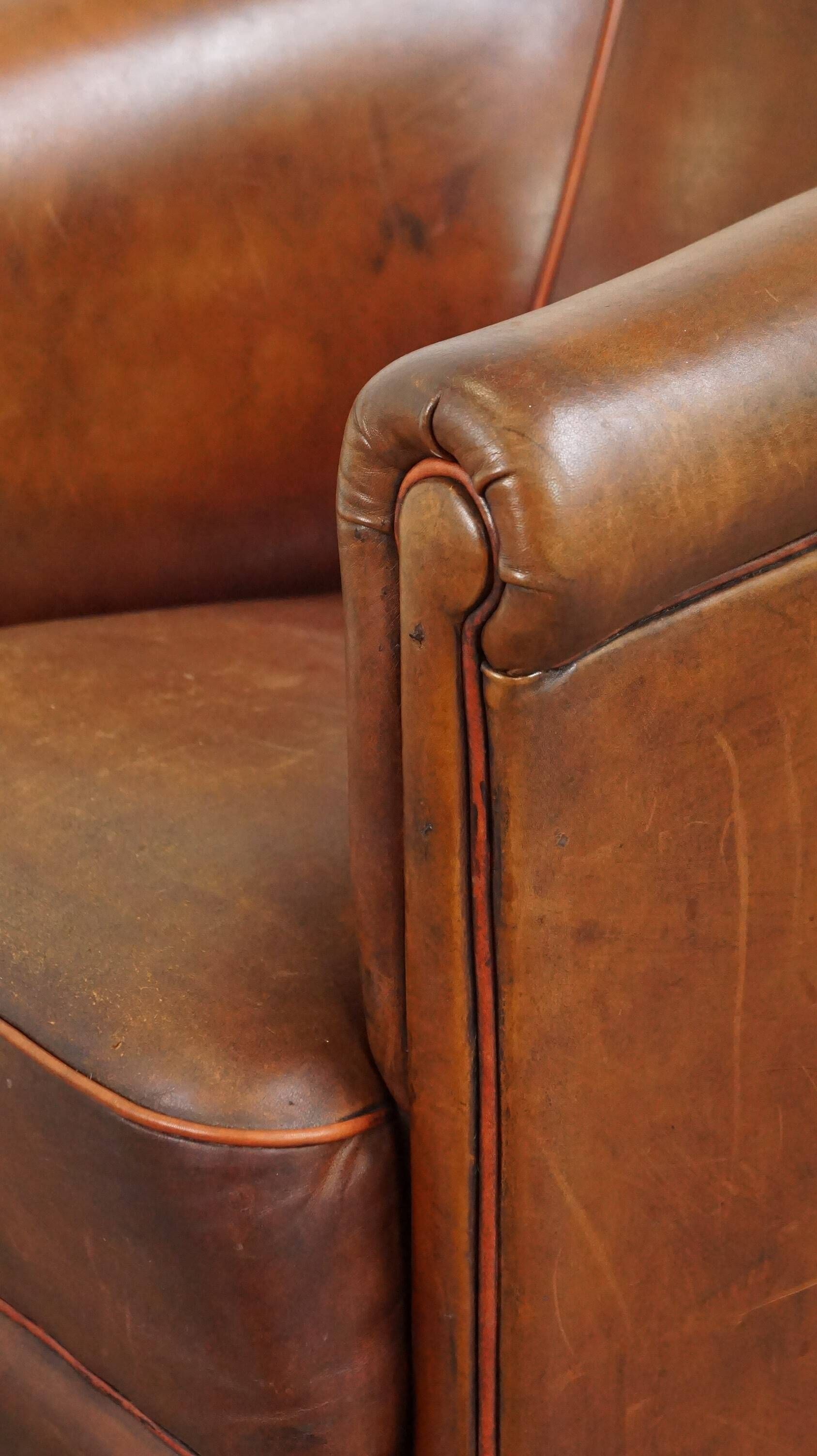 Neat, elegantly finished, cozy sheepskin club armchair with a fixed seat cushion