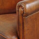 Neat, elegantly finished, cozy sheepskin club armchair with a fixed seat cushion