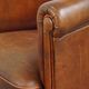 Neat, elegantly finished, cozy sheepskin club armchair with a fixed seat cushion