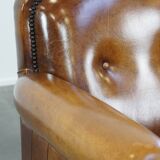 Sheep leather design armchair finished with decorative nails and black piping