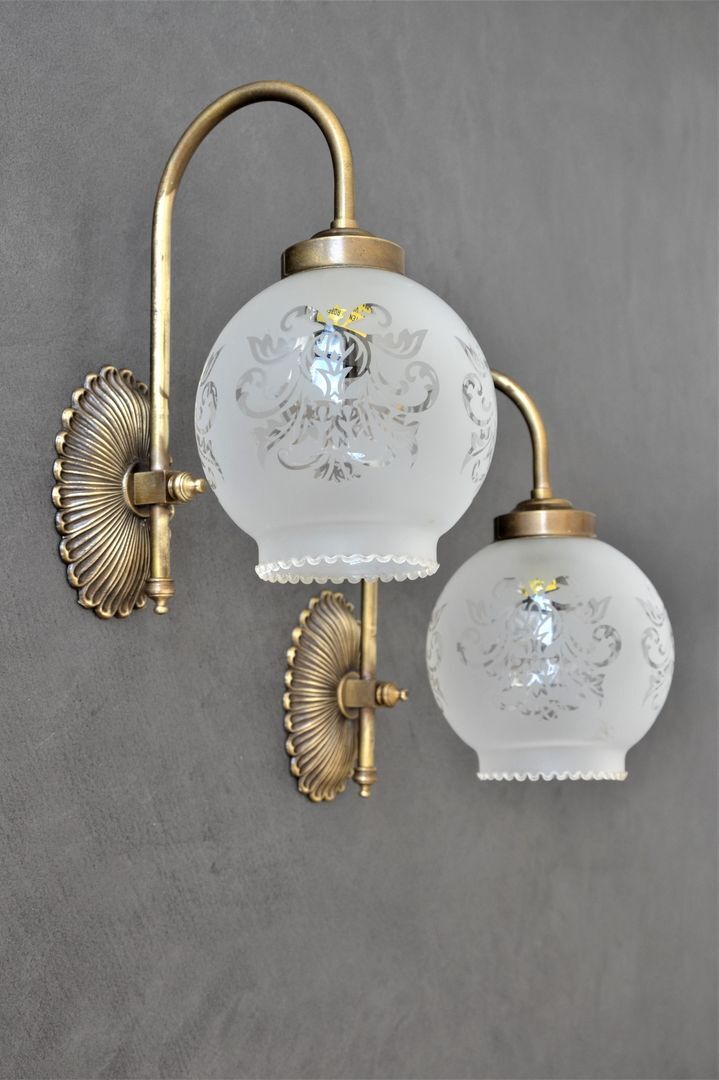 Pair of engraved glass wall lamps, brass support