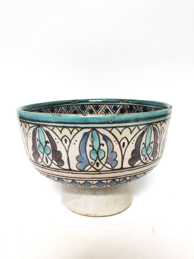 Cup on a ceramic pedestal – blue and turquoise geometric design.