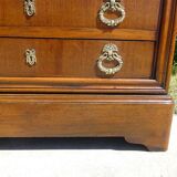Chest of drawers with decorated handles in the Louis XVI style.
