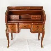Louis XV cylinder desk with floral marquetry and gilded ornaments.